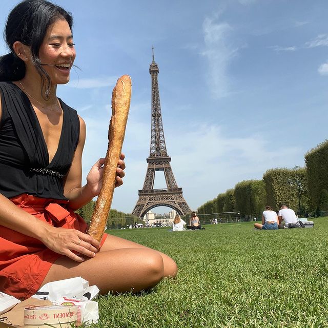 Instagram post: A girl and her baguette take the city of love