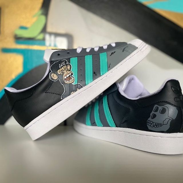 Instagram post: Custom FreshestKicks for my BAYC #3035 🦍 Artist: @sonz1 + @cherryd1 Shoe: @adidasoriginals Superstar @freshestkicks.eth ⚡️ #custom1of1 #...